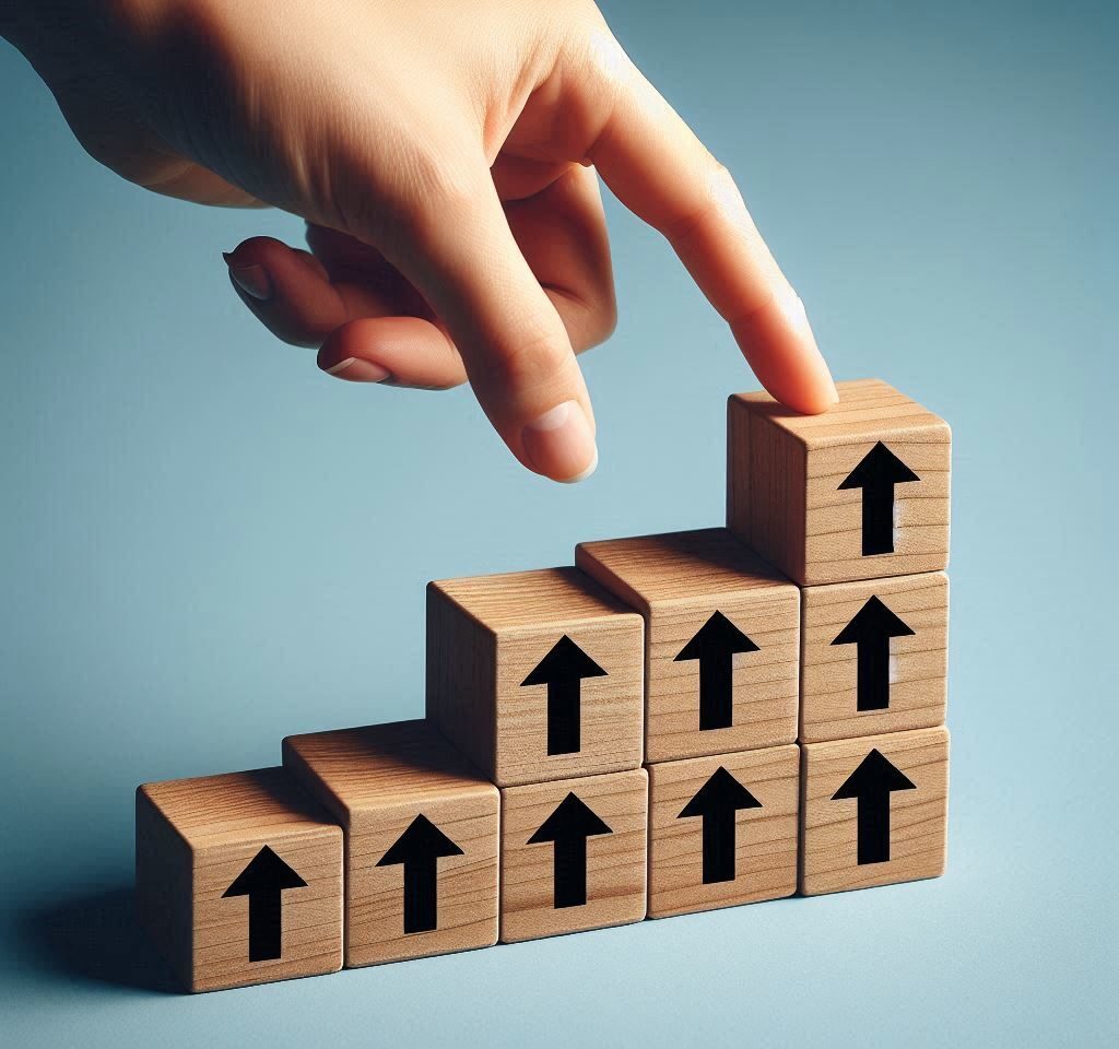 Each block has a black arrow pointing upwards, symbolizing growth or progress. The background is a plain, light blue surface that provides contrast to the wooden texture of the blocks.