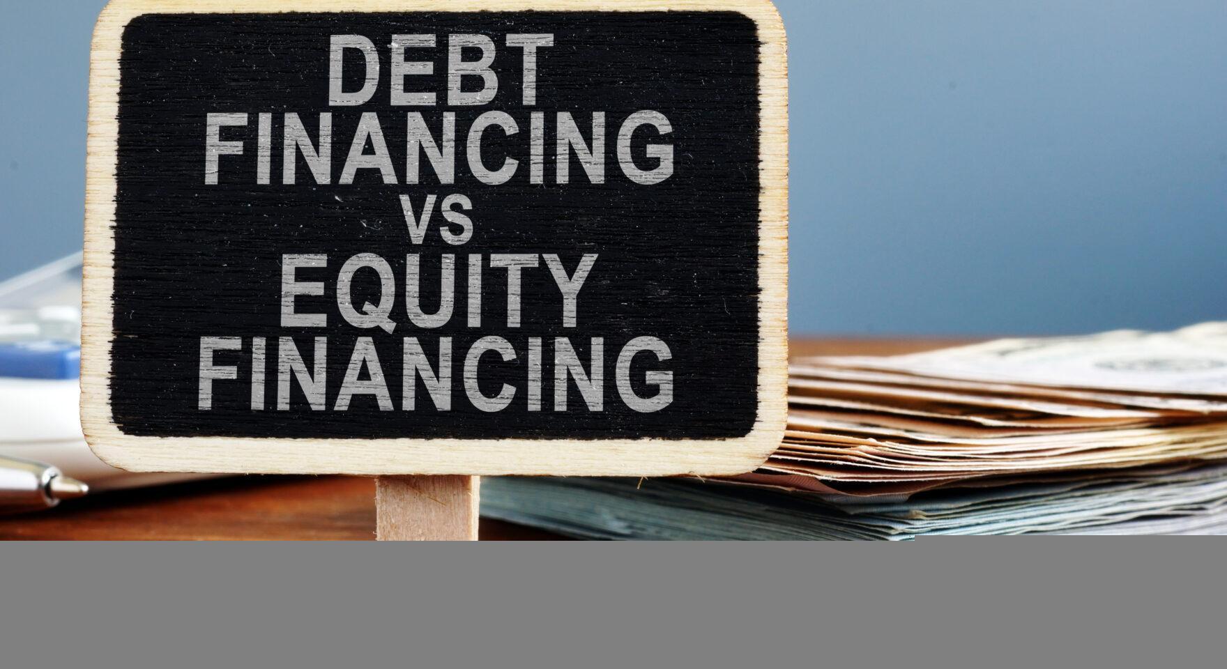 Debt financing vs equity financing concept. Calculator and cash.