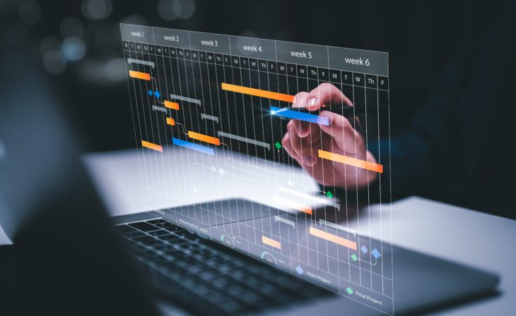 M&A planning and Implementation, Business people use laptop computers to manage work projects and update tasks. Work progress, efficient scheduling.Business Data Management scheduling