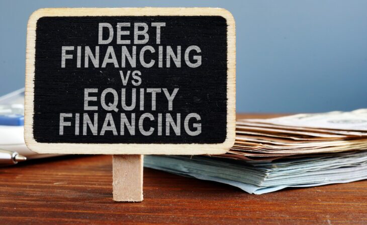 Debt financing vs equity financing concept. Calculator and cash.