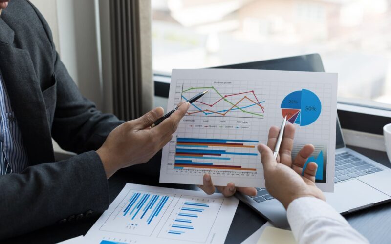 Close up business team analyzing income charts and graphs. FCFF and strategy concept.